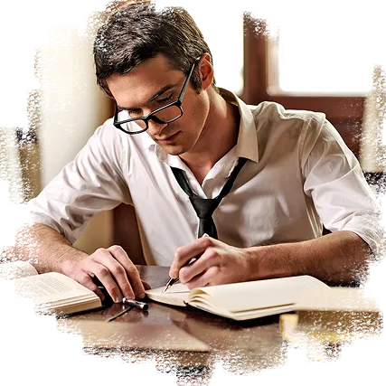 A man wearing glasses is focused on writing on a piece of paper at a desk.